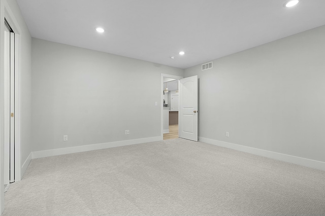 unfurnished bedroom featuring light carpet