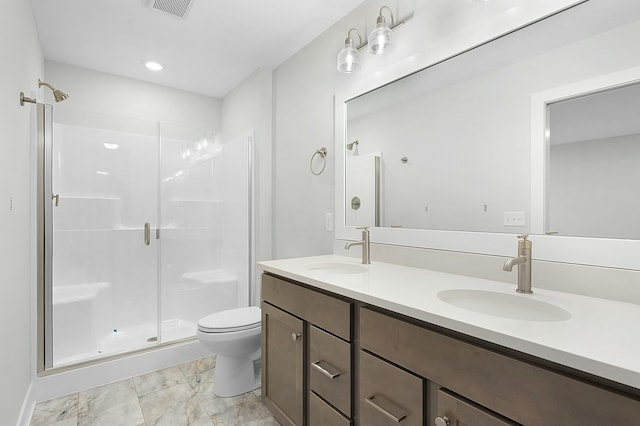 bathroom featuring vanity, toilet, and a shower with shower door