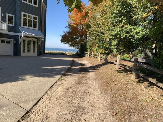 view of road with driveway and a water view