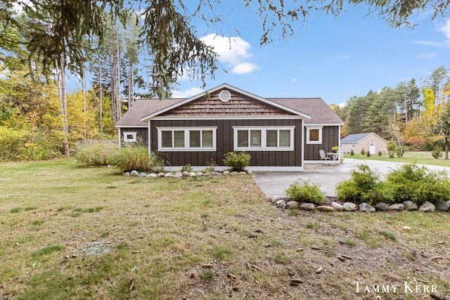 view of front of house with a front yard and a patio