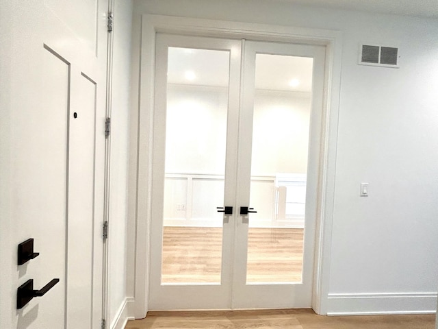 doorway featuring french doors and light hardwood / wood-style flooring