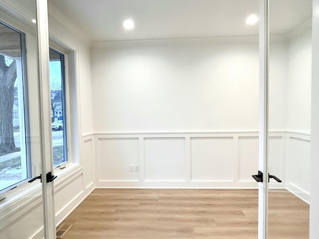 unfurnished room with light wood-type flooring and french doors