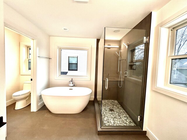 bathroom with toilet and plus walk in shower