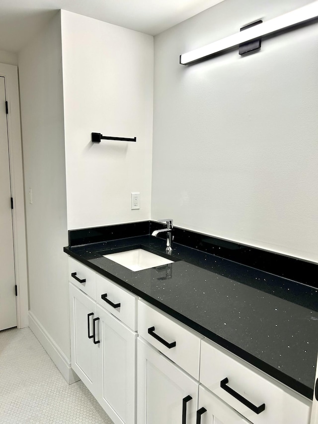 bathroom with tile patterned flooring and vanity