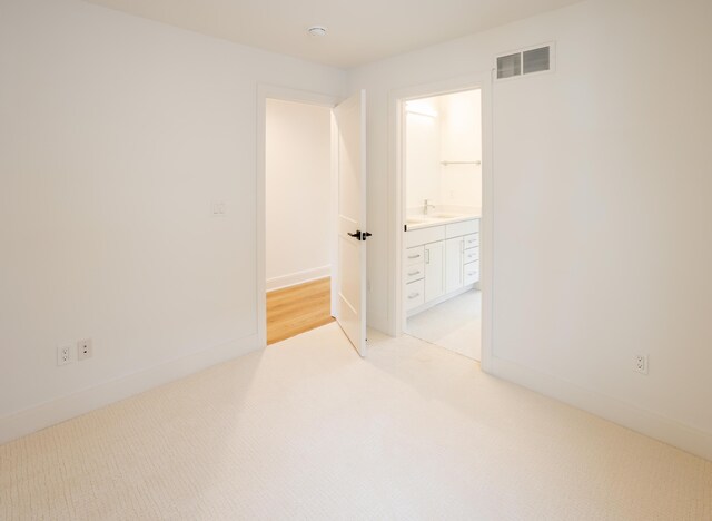 carpeted spare room featuring sink