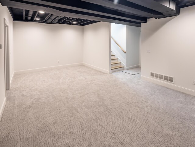 basement featuring light carpet