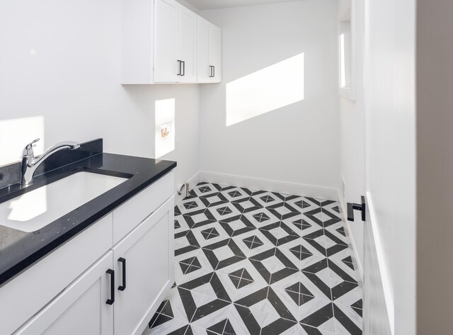 laundry area with sink and cabinets