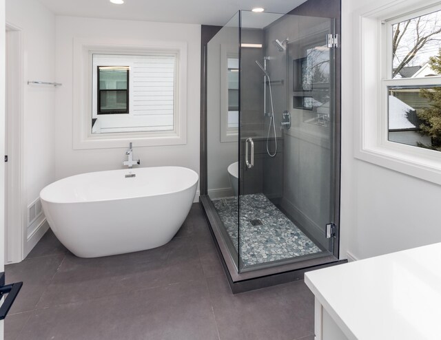 bathroom with shower with separate bathtub and vanity