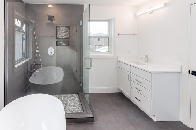 bathroom featuring vanity and independent shower and bath