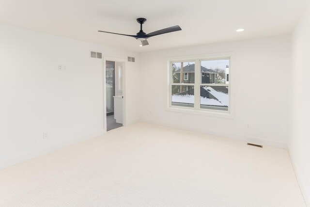 unfurnished room with ceiling fan and carpet