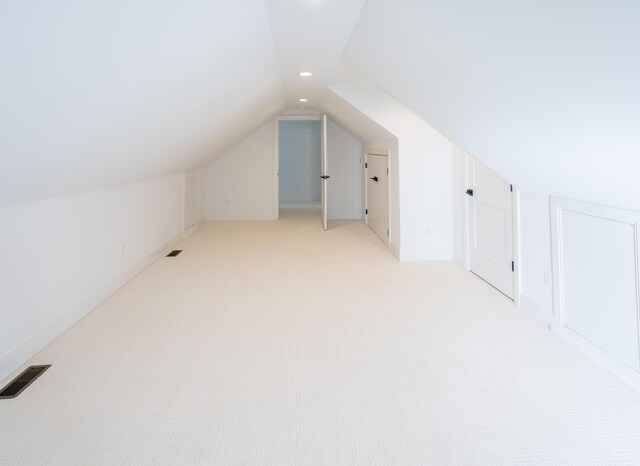 bonus room featuring light colored carpet and lofted ceiling