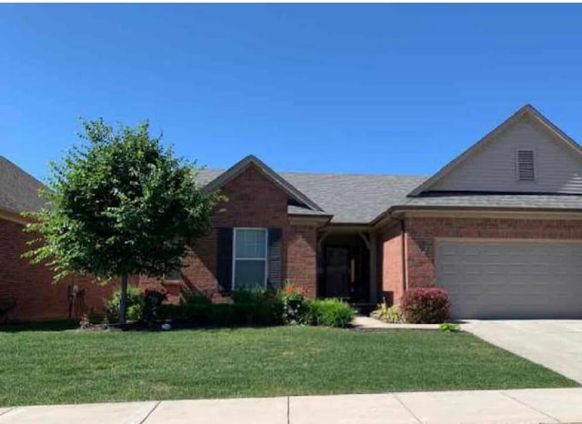 ranch-style home featuring a garage and a front yard