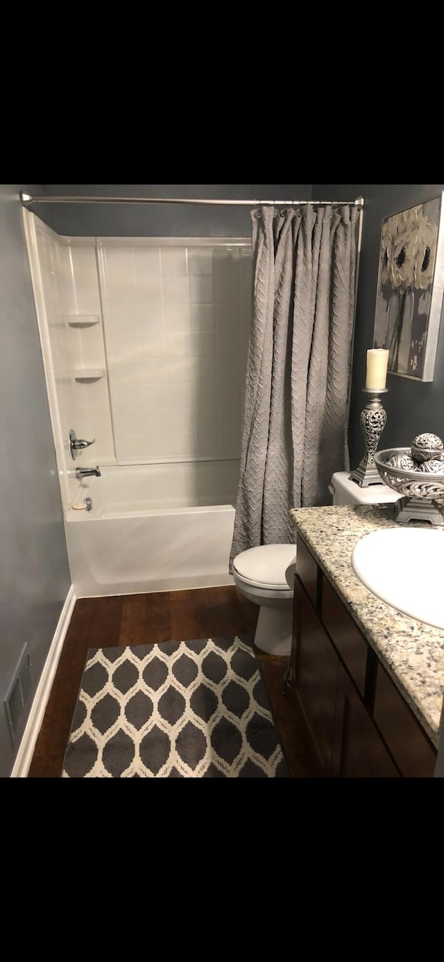 full bathroom with vanity, toilet, and shower / tub combo