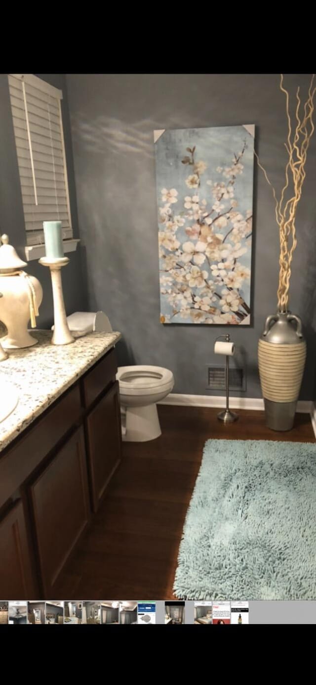 bathroom featuring vanity, hardwood / wood-style flooring, and toilet