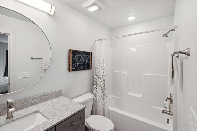 full bathroom with vanity, toilet, and shower / bathtub combination with curtain