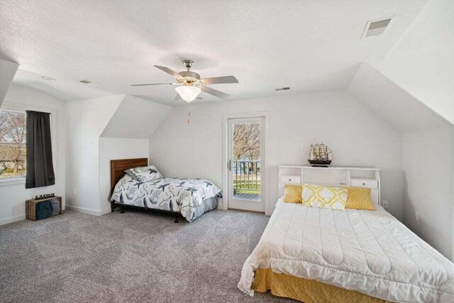 carpeted bedroom with lofted ceiling, a textured ceiling, access to exterior, and ceiling fan