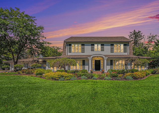 colonial home featuring a yard