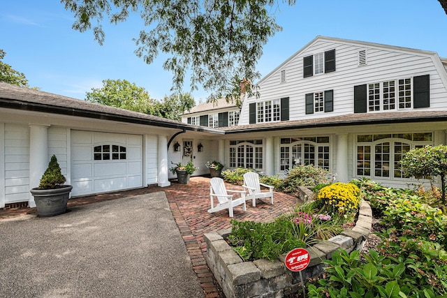 back of property featuring a garage