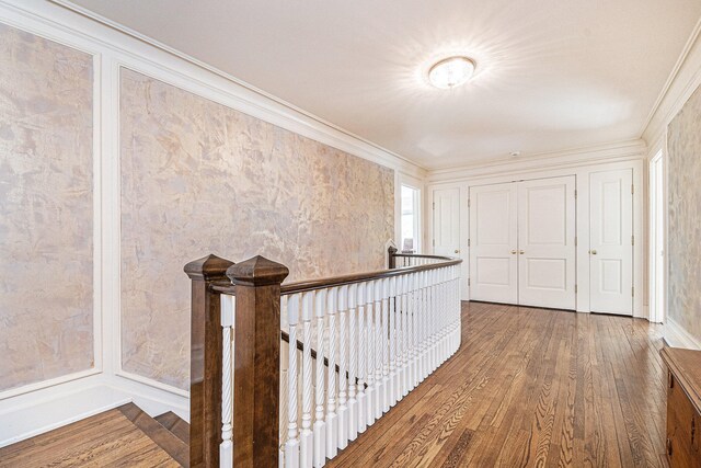 hallway with crown molding and hardwood / wood-style flooring