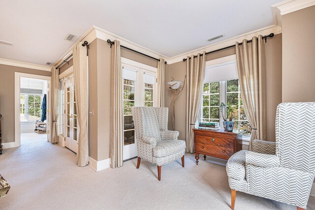 sitting room featuring ornamental molding and light colored carpet