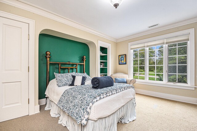 carpeted bedroom with ornamental molding