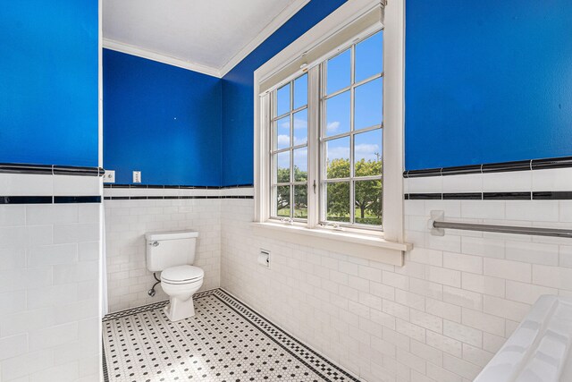 bathroom featuring toilet, ornamental molding, tile walls, and tile patterned flooring