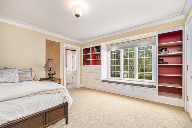 bedroom featuring ensuite bathroom, ornamental molding, and carpet floors