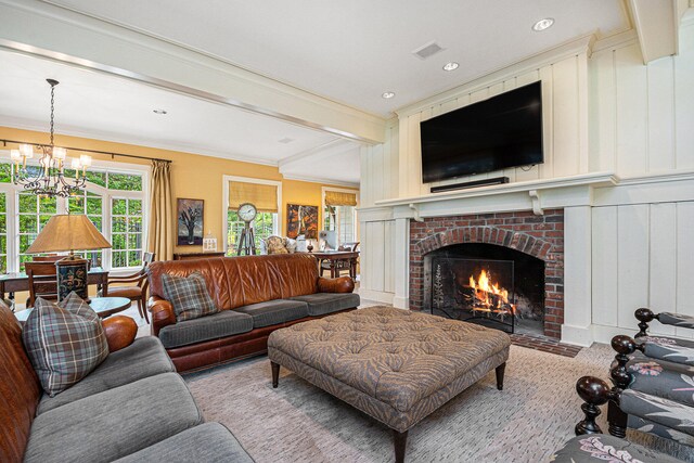 living room with ornamental molding, beam ceiling, a chandelier, and a fireplace