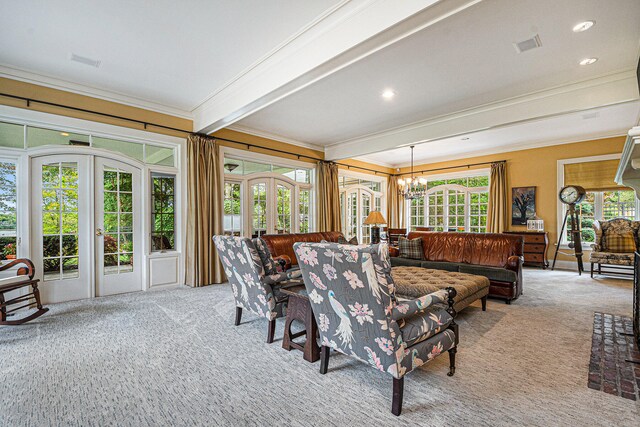 living room featuring beamed ceiling, an inviting chandelier, light colored carpet, and ornamental molding