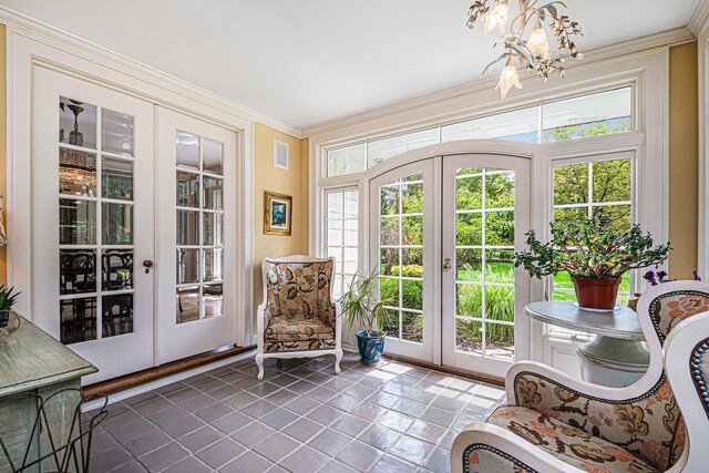 sunroom / solarium with french doors and a notable chandelier