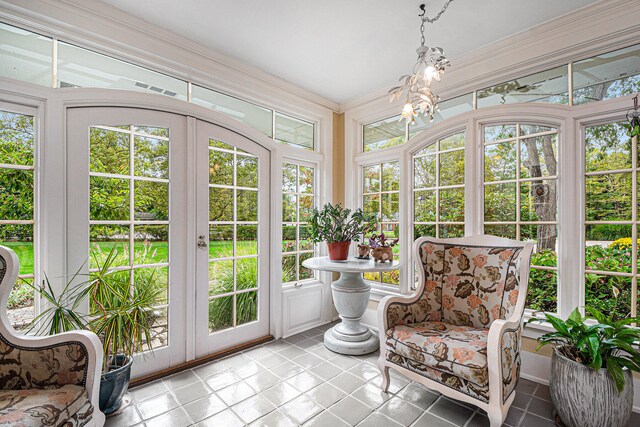 sunroom / solarium with a chandelier and a wealth of natural light