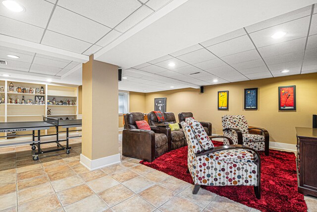 living room featuring a paneled ceiling, built in features, and light tile patterned floors