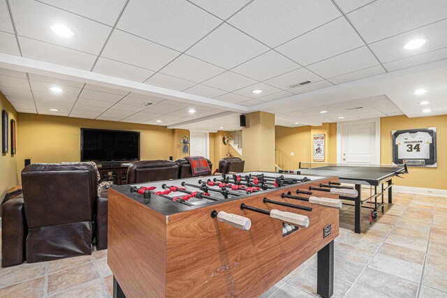 recreation room featuring a drop ceiling and light tile patterned flooring