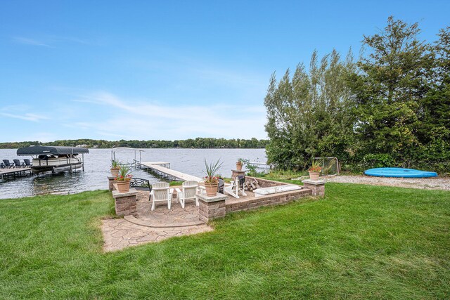 dock area with a yard and a water view