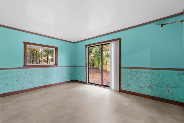 unfurnished room with crown molding and a healthy amount of sunlight