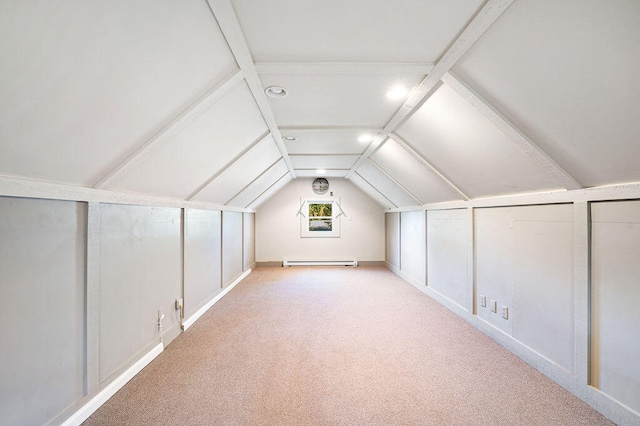 additional living space with vaulted ceiling, light carpet, and a baseboard heating unit