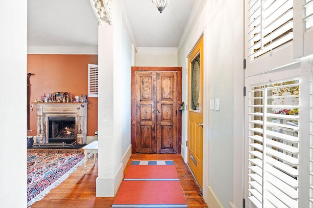 entryway featuring ornamental molding and wood-type flooring