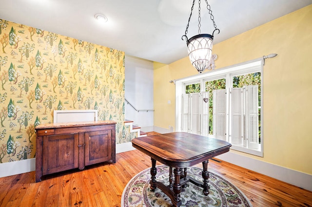 dining room with a notable chandelier and light wood-type flooring