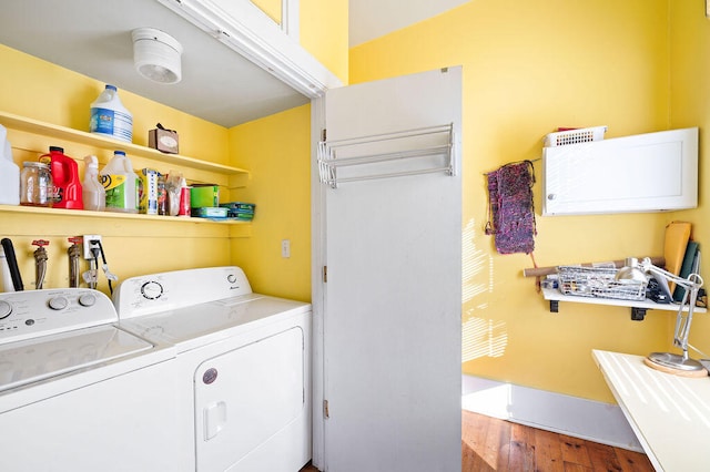 laundry room with hardwood / wood-style floors and independent washer and dryer