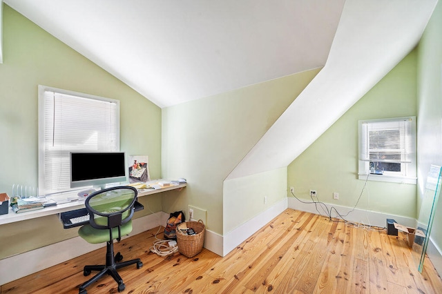 office featuring vaulted ceiling, a wall mounted air conditioner, and light hardwood / wood-style floors