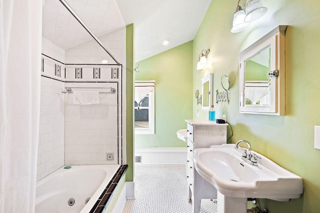 bathroom with tile patterned floors, shower / tub combo, and sink