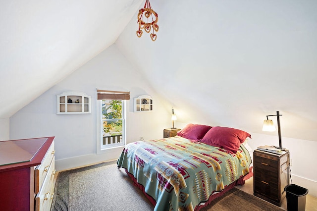 bedroom featuring dark carpet and lofted ceiling