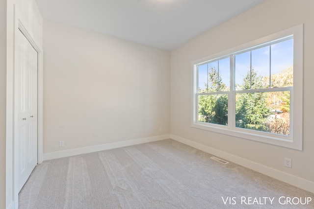 empty room featuring light carpet