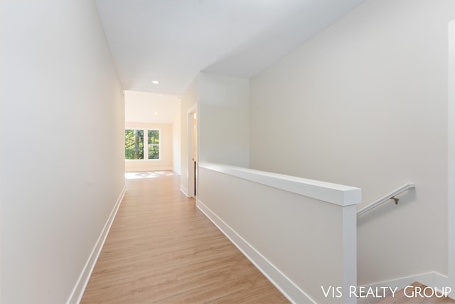 hallway with light hardwood / wood-style floors