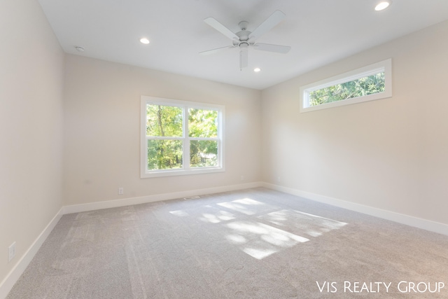 empty room with a healthy amount of sunlight, carpet, and ceiling fan