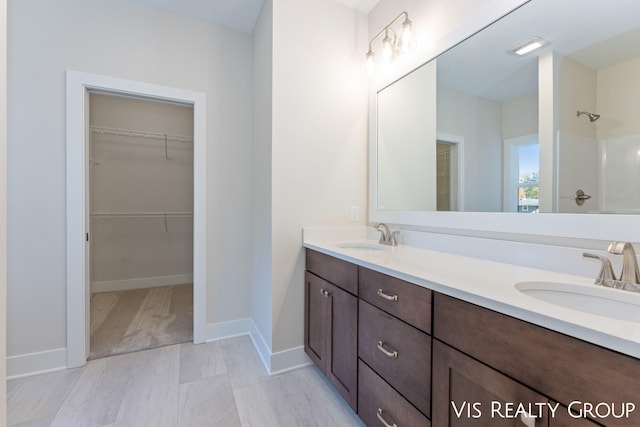 bathroom featuring vanity and a shower