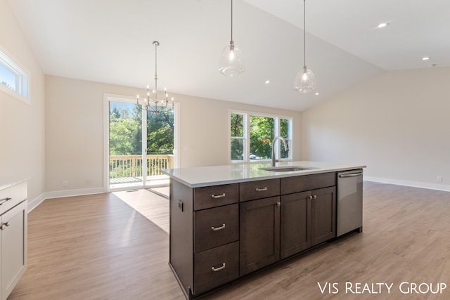 kitchen featuring a wealth of natural light, stainless steel dishwasher, sink, and lofted ceiling