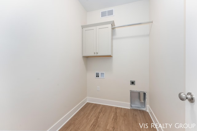 clothes washing area featuring cabinets, hookup for an electric dryer, washer hookup, and light hardwood / wood-style floors