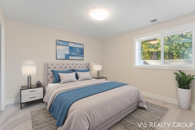 bedroom featuring light colored carpet