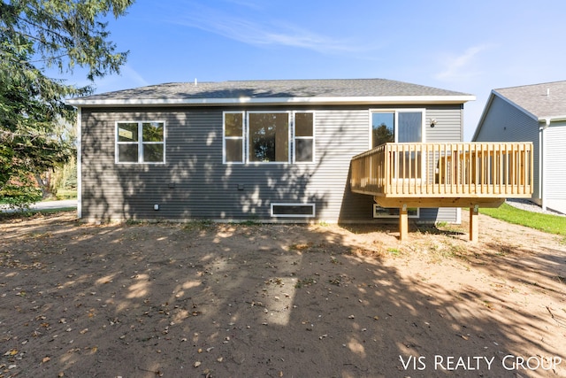 rear view of house featuring a wooden deck